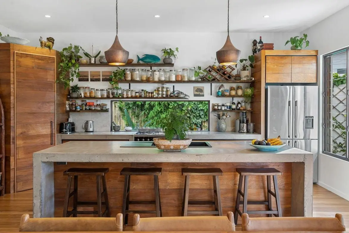 Kitchen island with timber stools and copper pendants