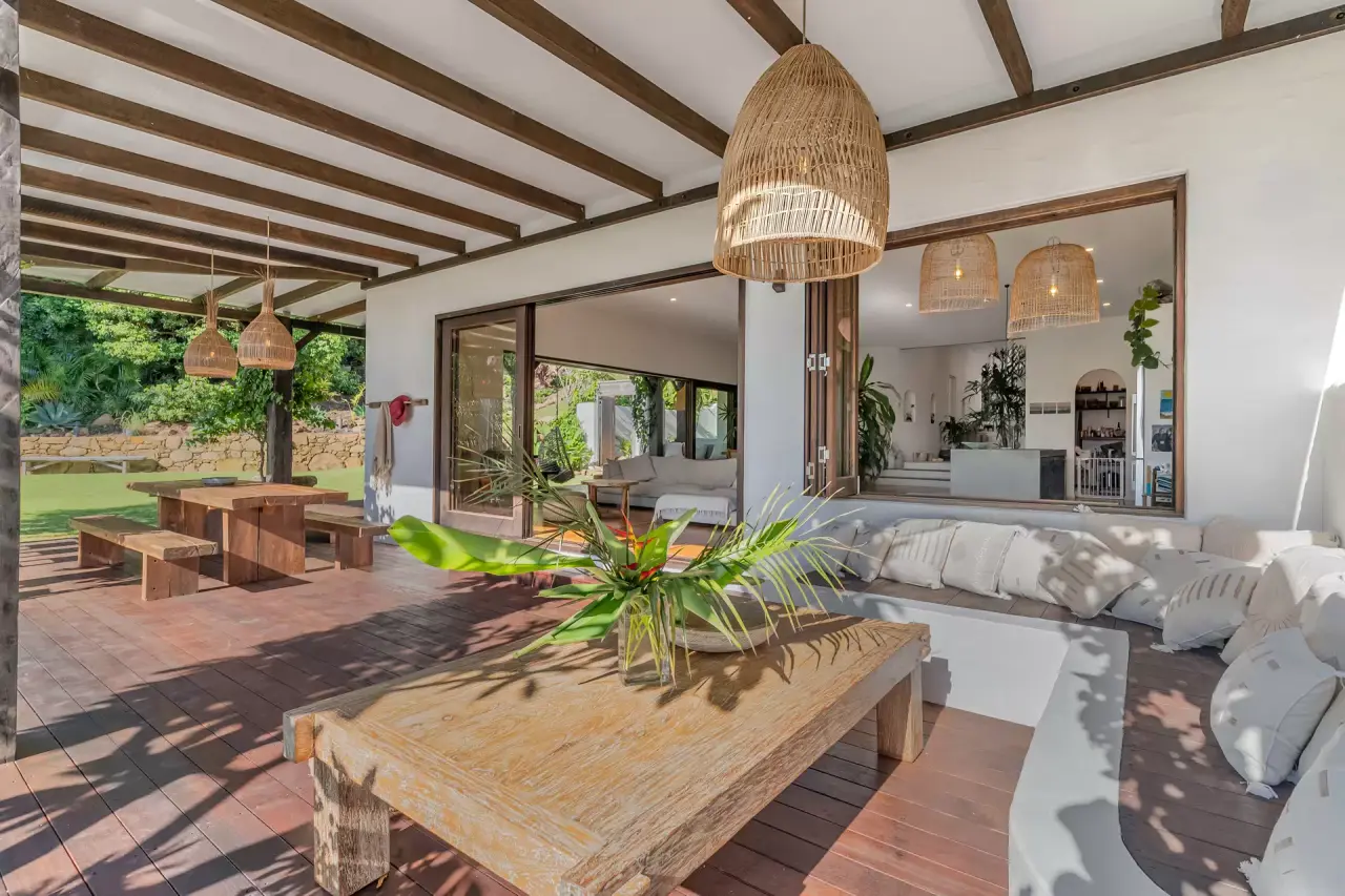 Covered alfresco deck with timber beams and outdoor seating