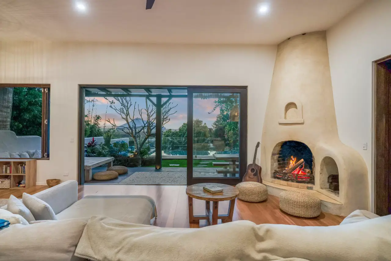 Lounge with a curved fireplace and garden view