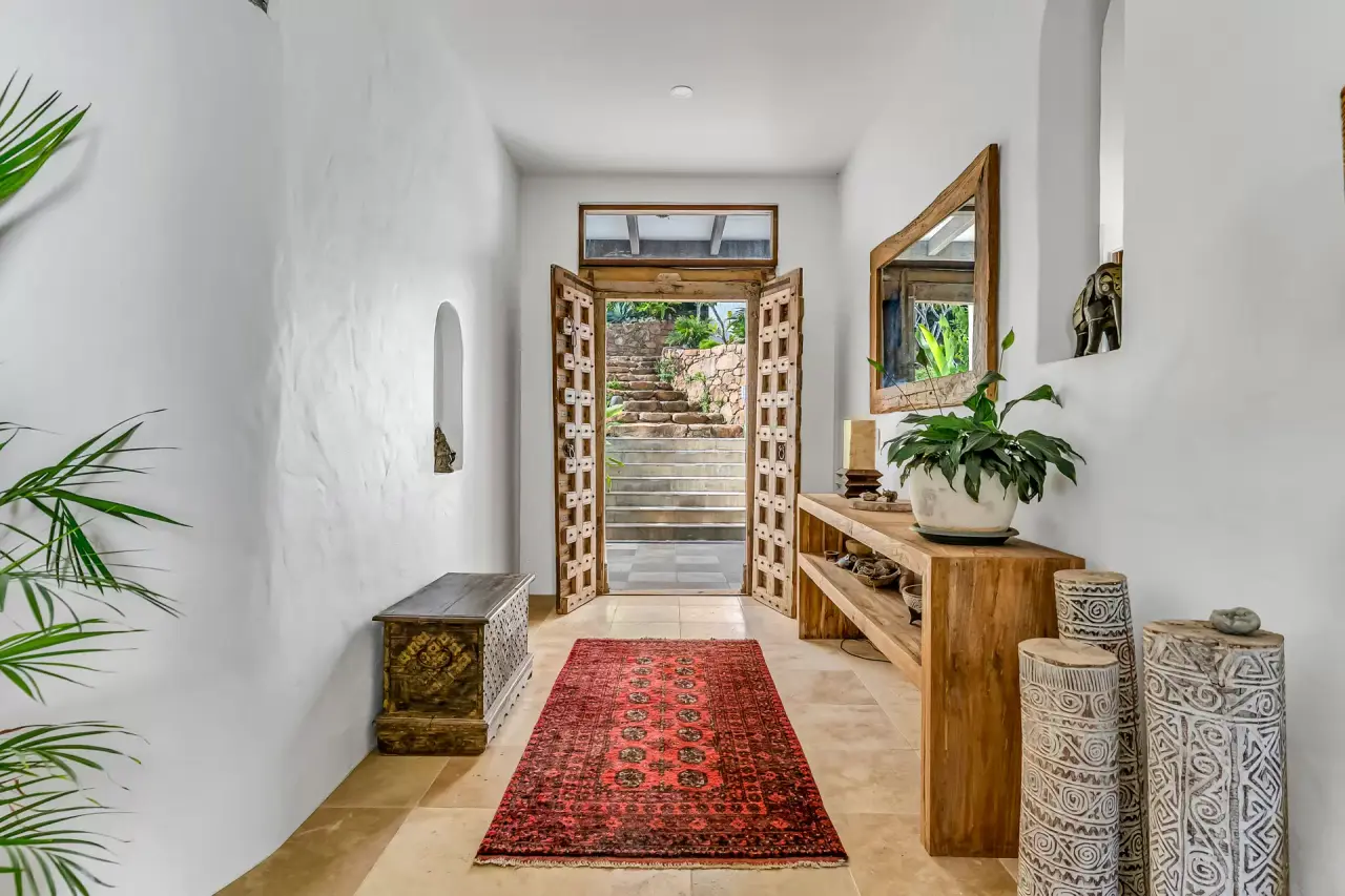 Hallway with timber doors and a woven rug