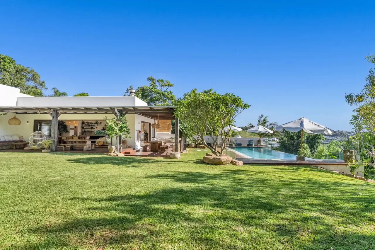 Level lawn in front of the house and pool