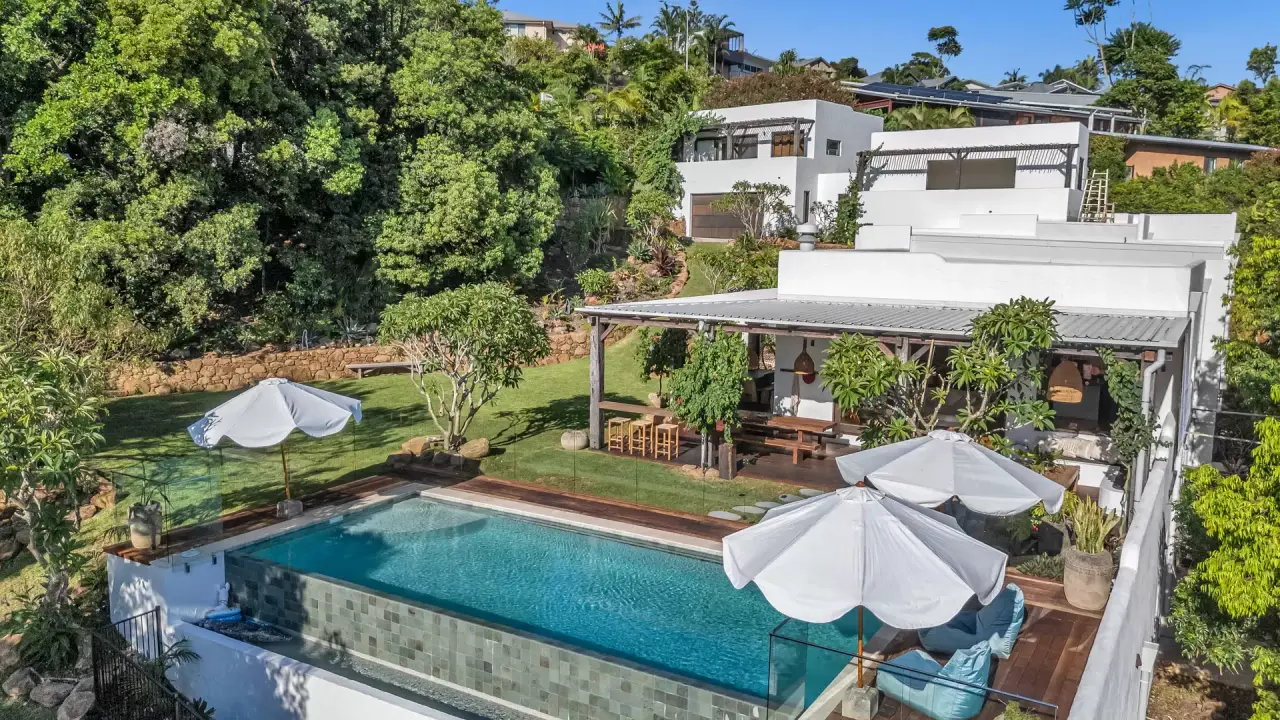 Aerial view of the house and pool deck among the gardens
